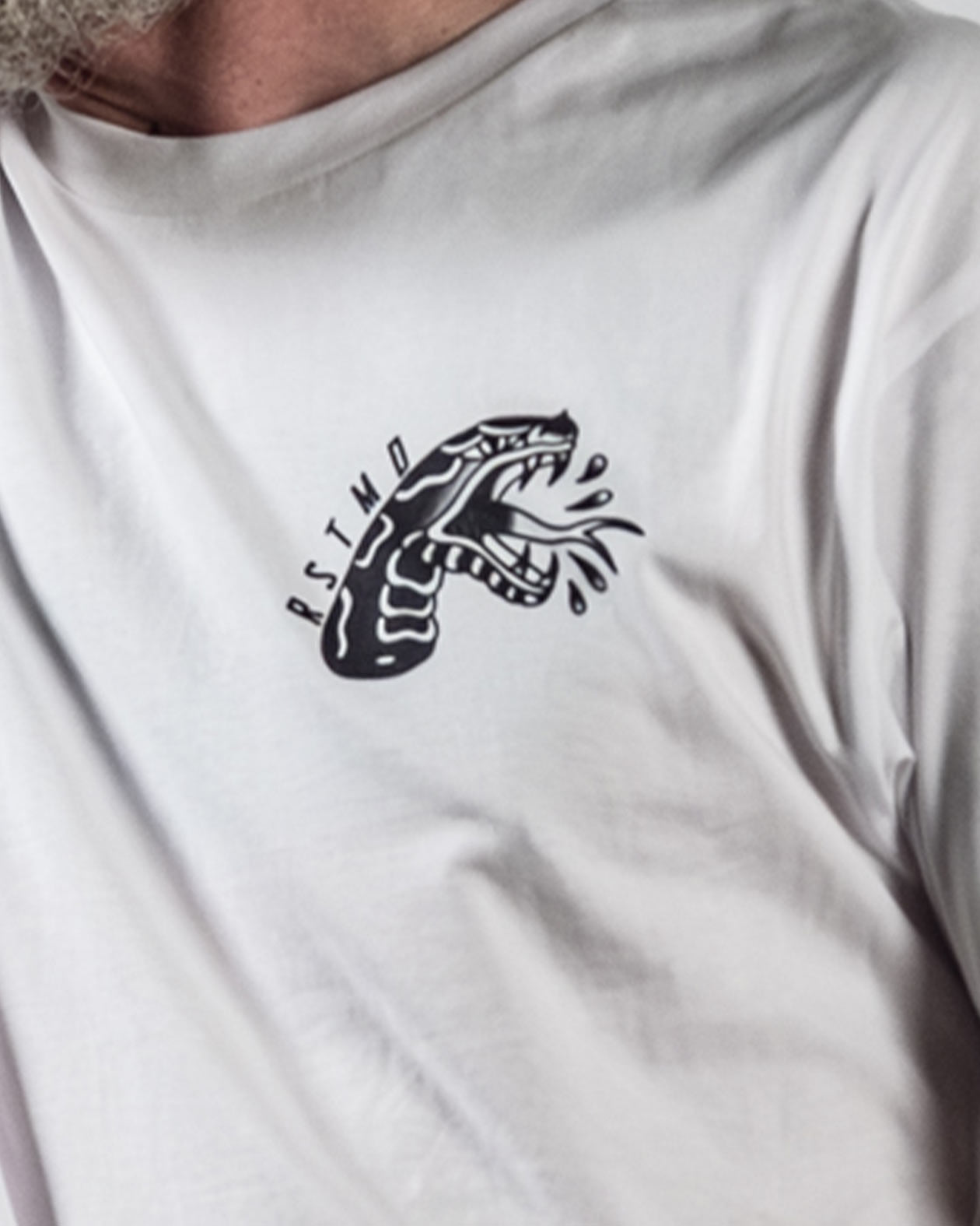 man wearing the don't kill my vibe graphic tee showing the upper left chest