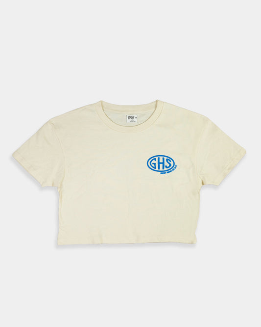 Beige crop top t-shirt with a blue logo on a white background - Buckle Up Crop Top by Greasy Hands Society