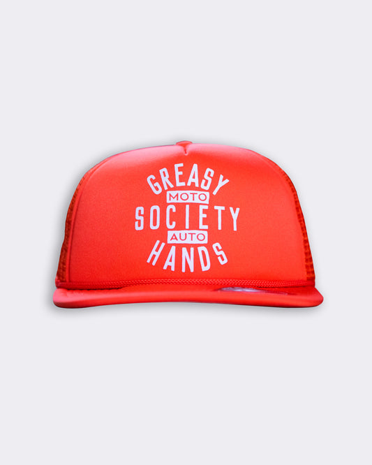 orange station hat with greasy hands society moto auto on the front flat lay front view on a gray background