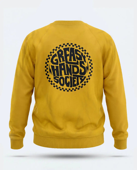 A mustard yellow crewneck sweatshirt shown from the back, featuring a large black circular graphic with the text 'GREASY HANDS SOCIETY' inside a checkered border - The Slicks Sweatshirt by Greasy Hands Society