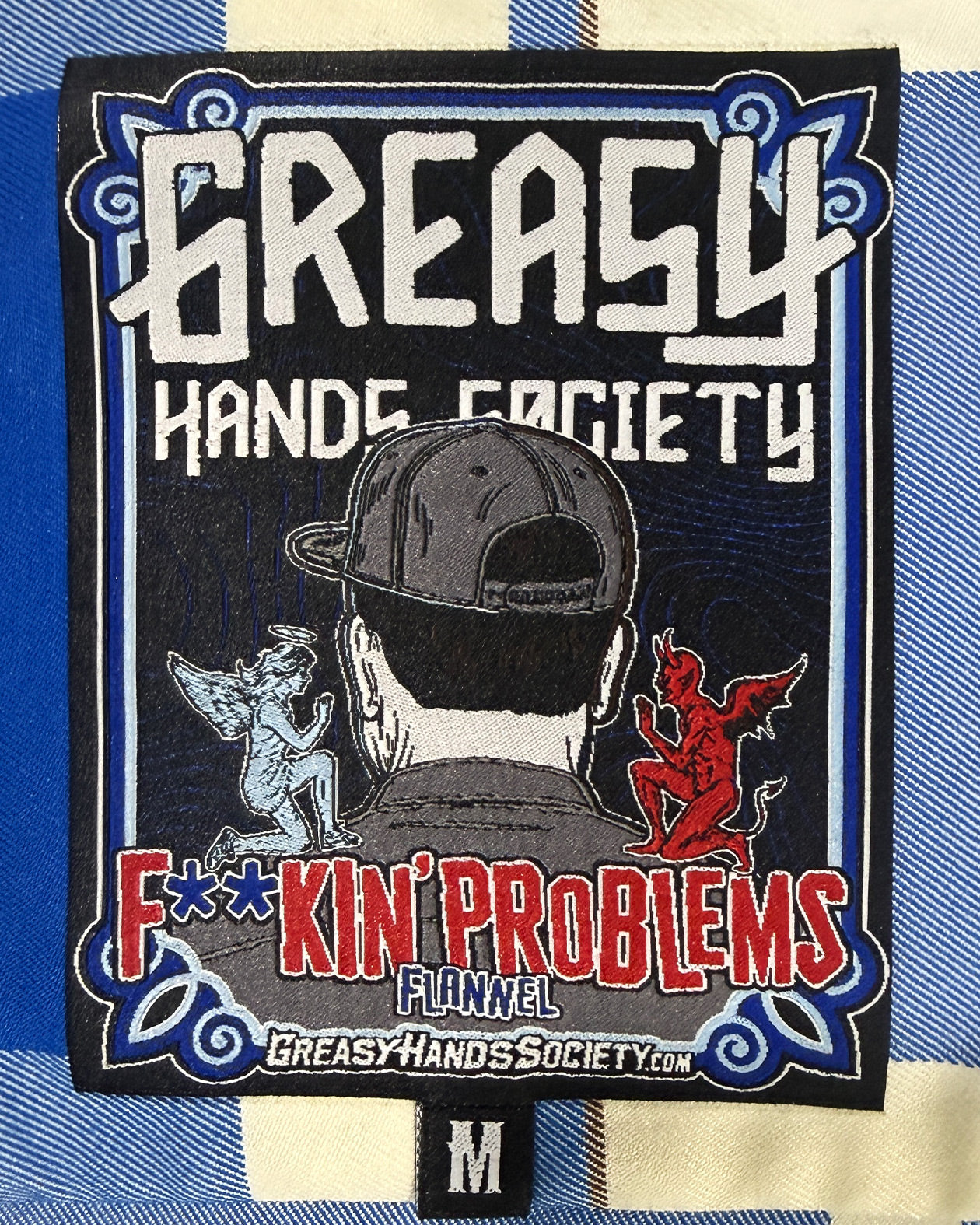 tag for F**kin Problems Flannel with 'Greasy Hands Society' text and graphics on a blue and white background