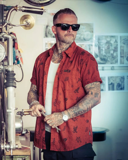 Man in a red patterned shirt and sunglasses working with coffee equipment - The 1776 button up short sleeved shirt by Greasy Hands Society