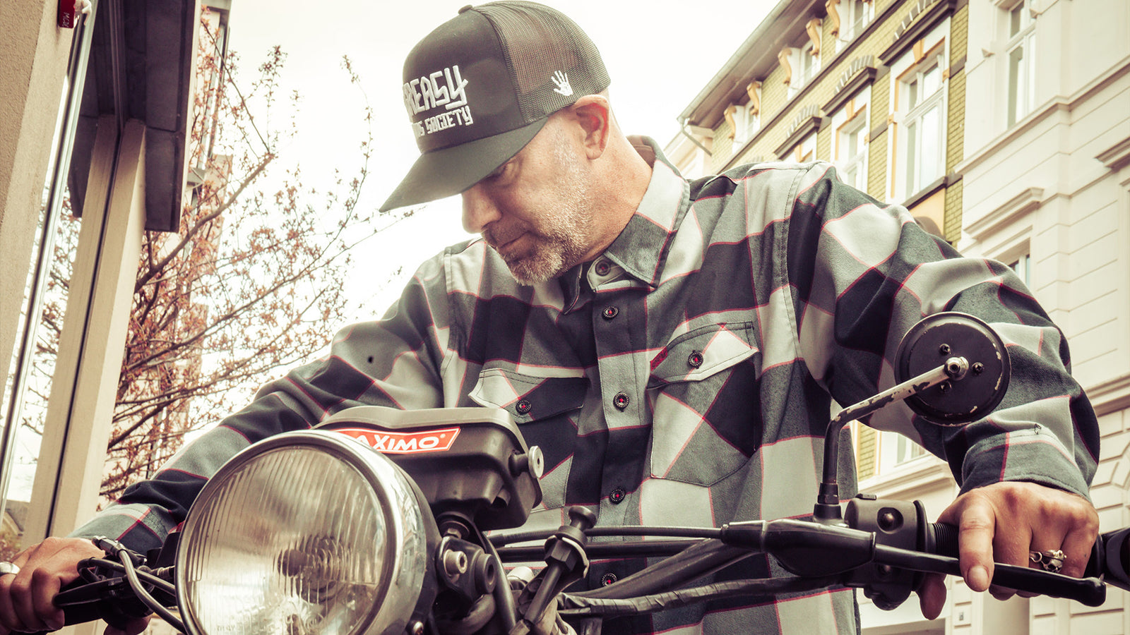 the banger black grey and red flannel worn on a motorbike