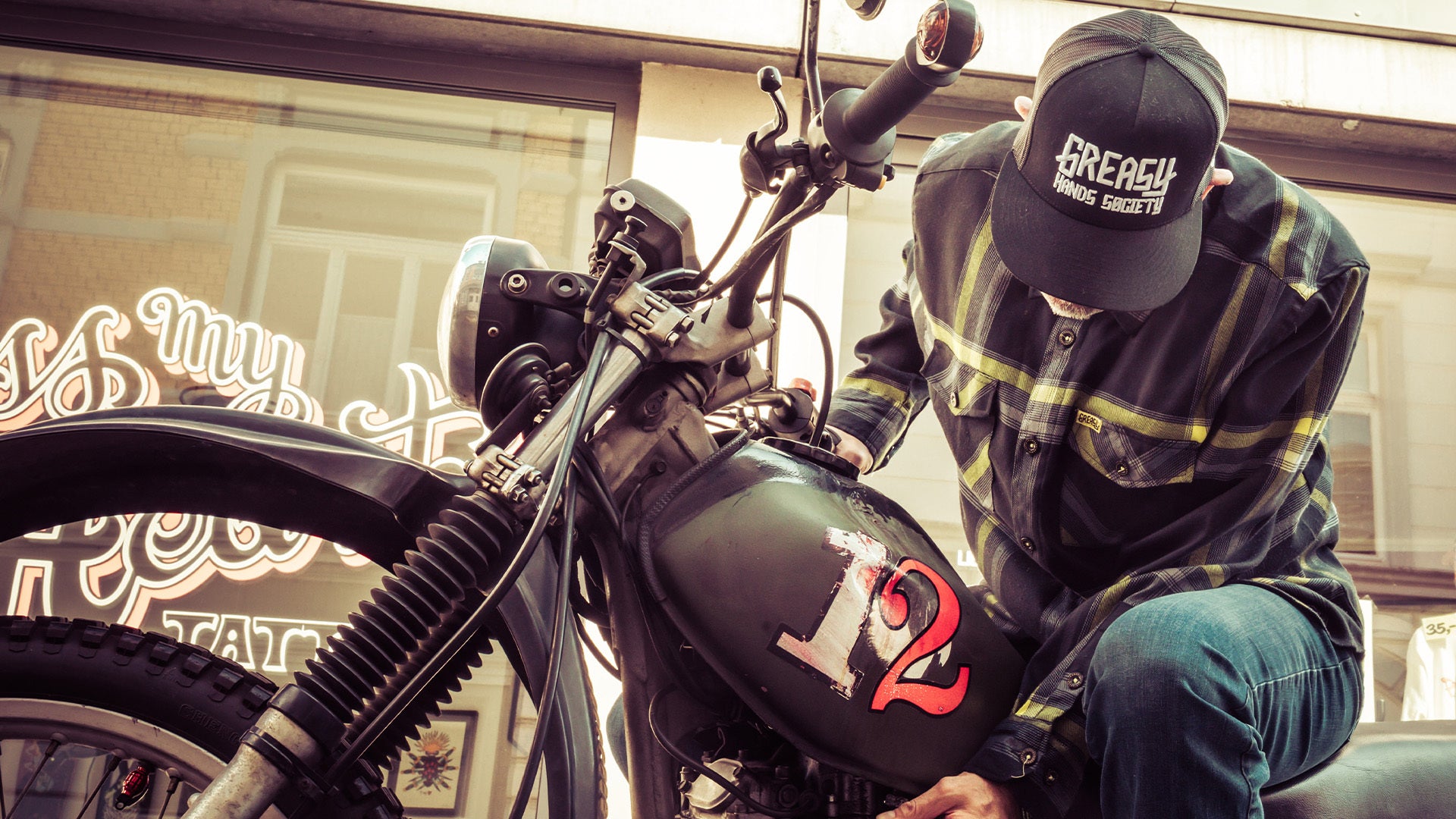 eat dust flannel in black and yellow plaid pattern worn by a motorcycle rider