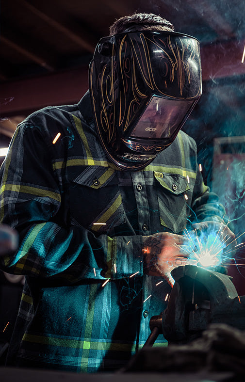 eat dust Flannel black gray and yellow flannel on someone welding a piece or his classic car