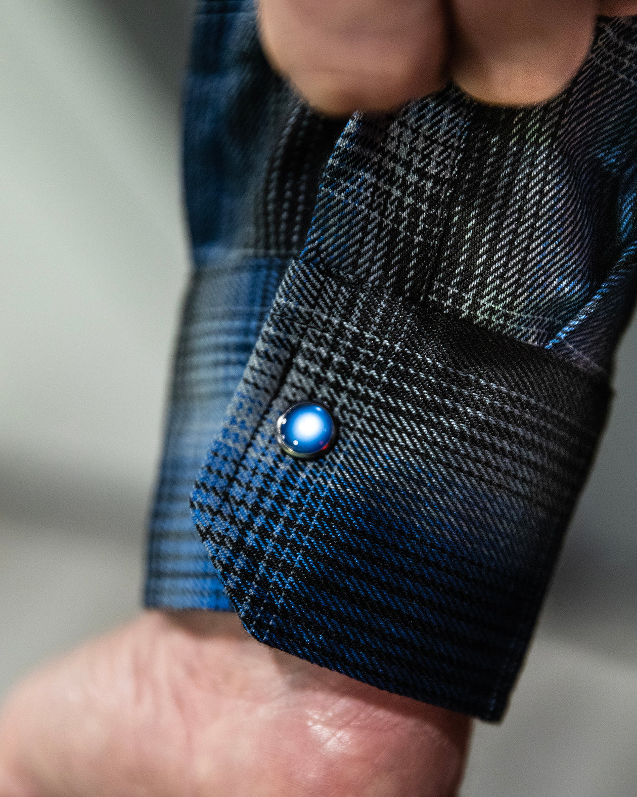 nailhead flannel blue and black flannel - person showing off the cuff of the flannel with the pearl snap button