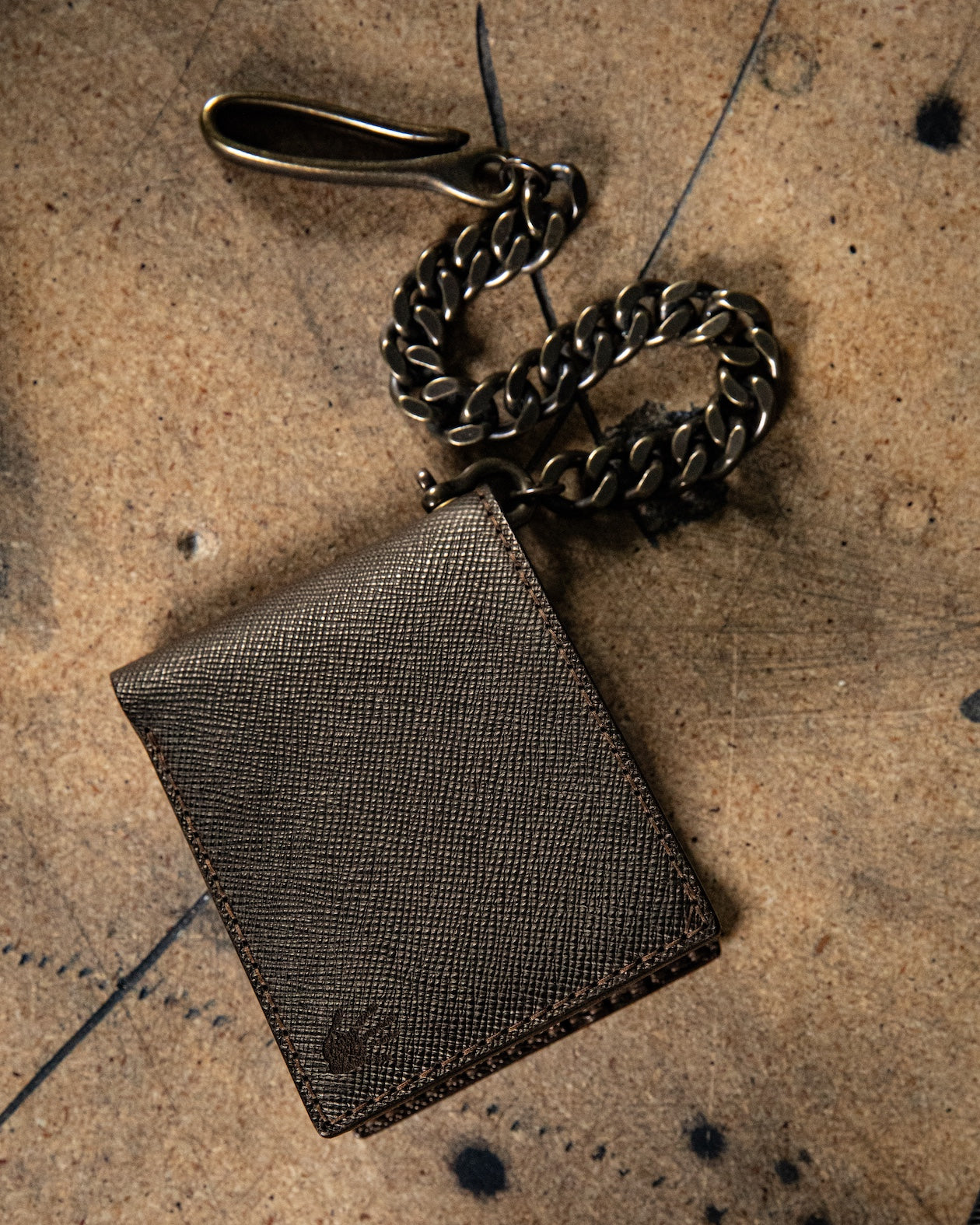 brown leather wallet with chain on a textured surface