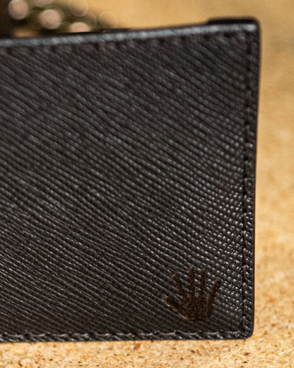 Close-up of a BROWN textured wallet with a brand logo on a beige surface