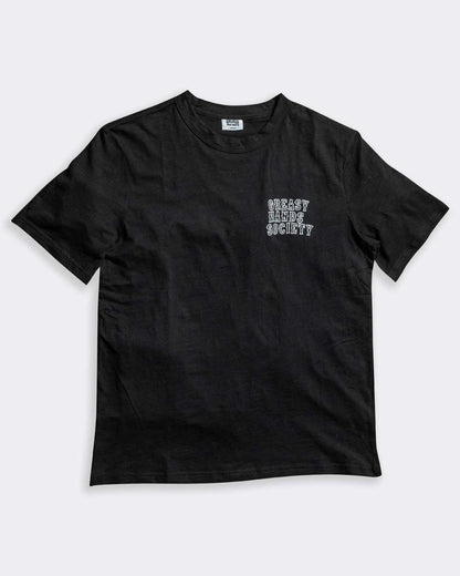 eat dust black graphic t-shirt front left chest graphic on gray flat lay