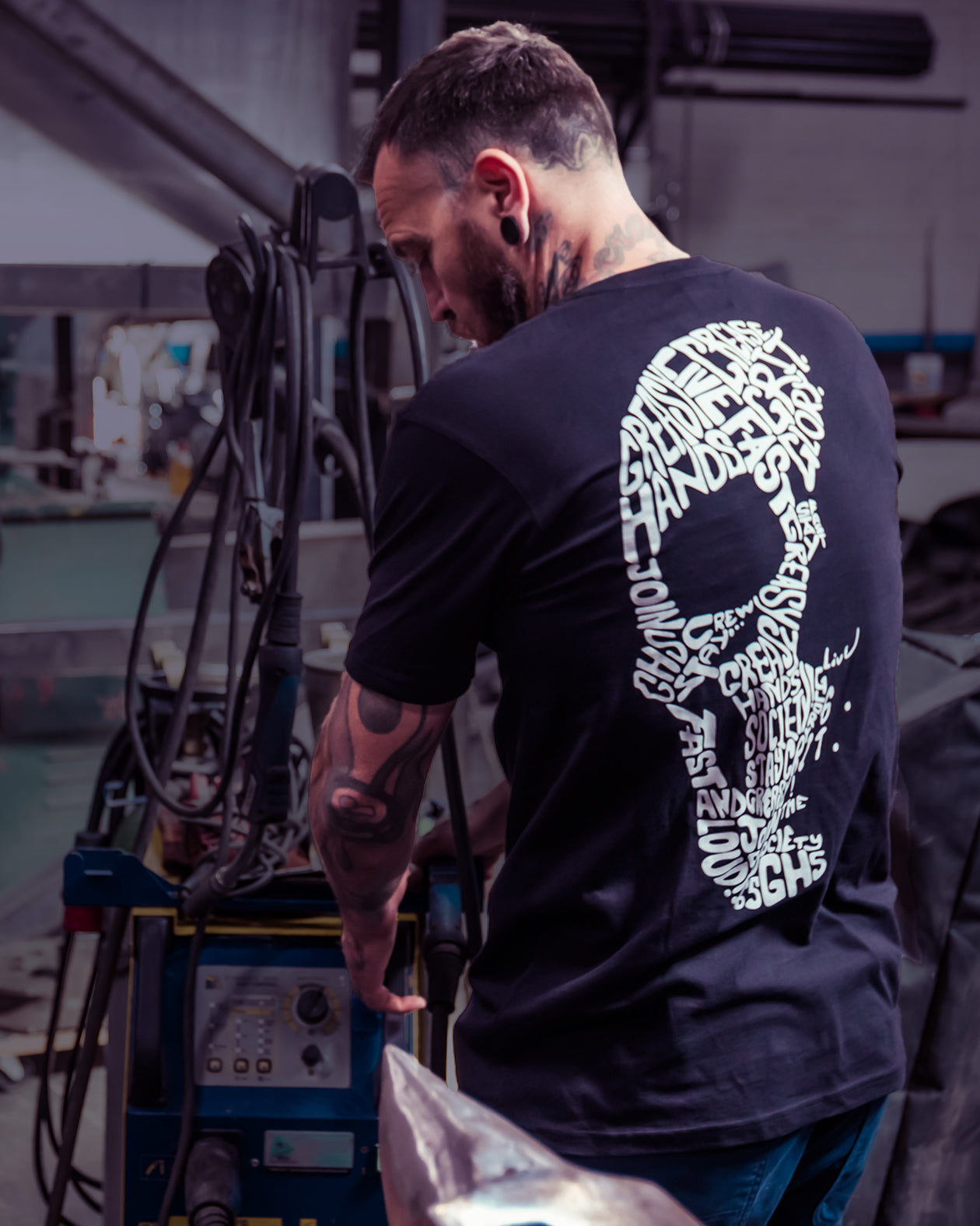 way of life black t-shirt on a model with the words live fast stay greasy in a skull shape
