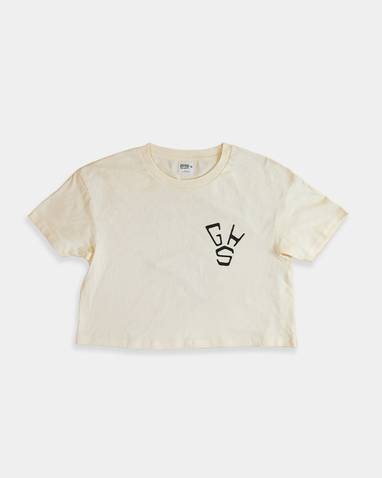 Beige cropped t-shirt with a black GHS design for women on the front left chest on a white background