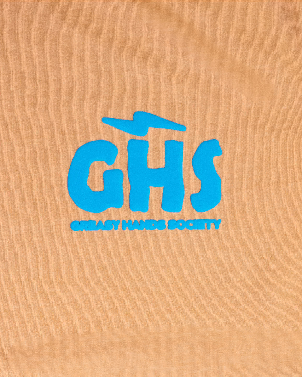 Blue 'GHS' logo on a orange graphic tee for women