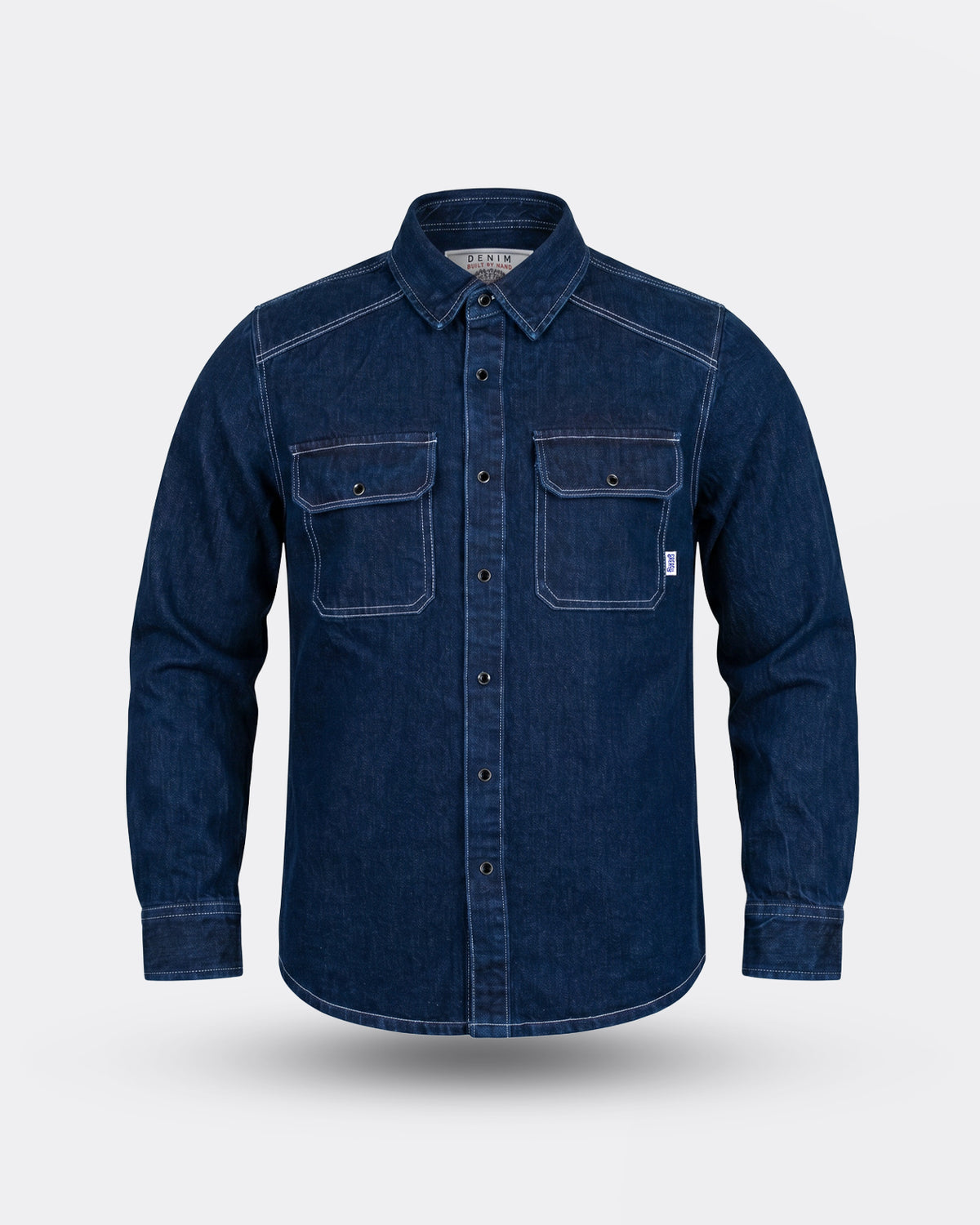 Blue indigo denim shirt on a light gray background - The Wanderer Denim Shirt by Greasy Hands Society