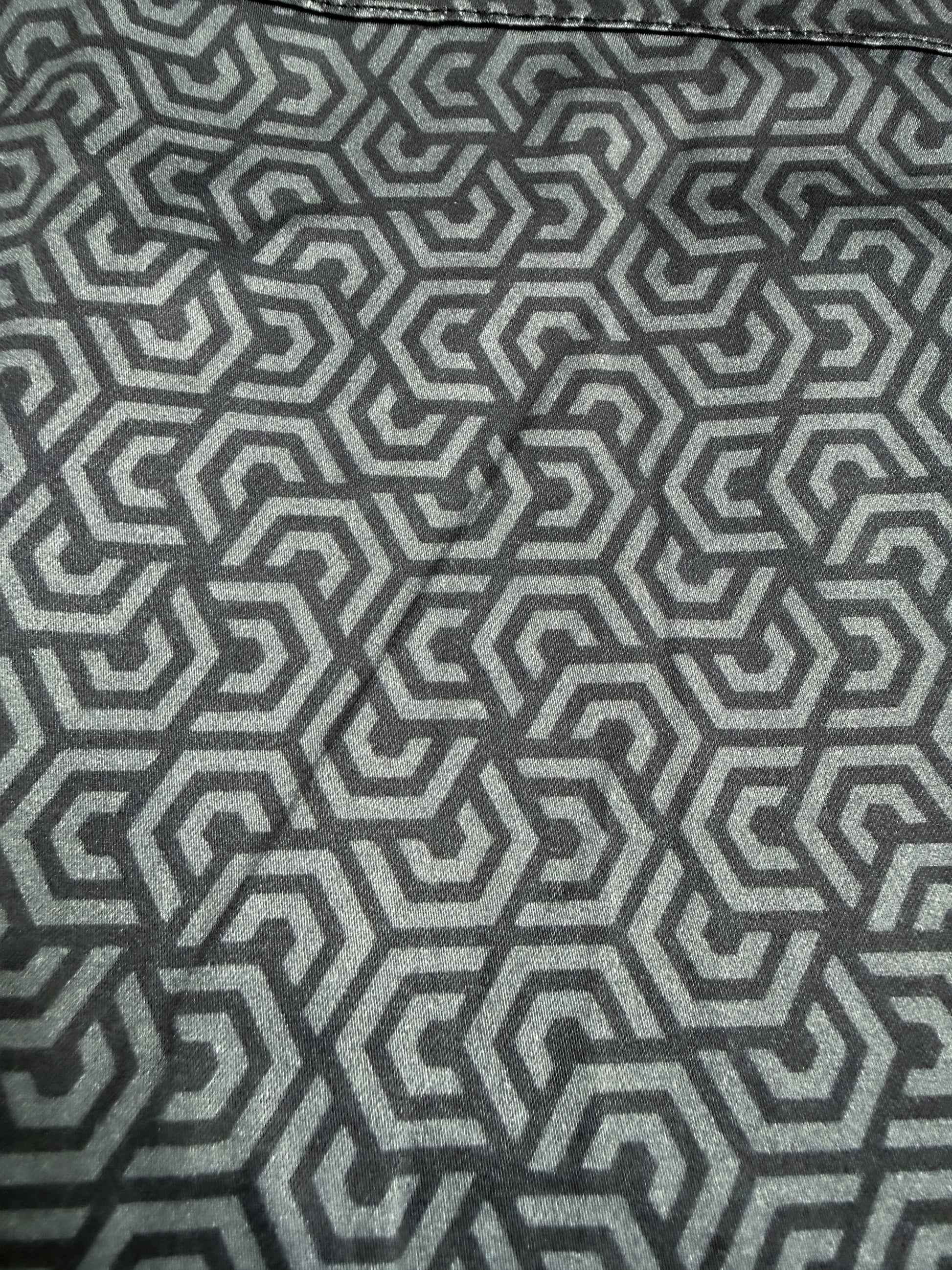 Close-up of a black and gray geometric patterned fabric with a repeating maze-like hexagon design - The Burnout Button-Up Shirt by Greasy Hands Society