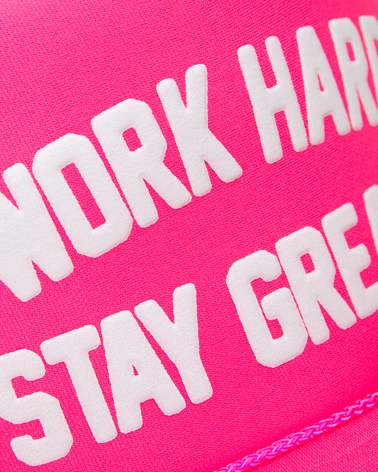 work hard stay greasy neon pink hat front detail of stitching of the letters