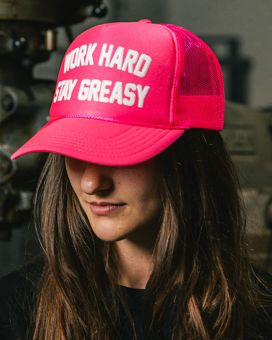 women's neon pink trucker hat with work hard stay greasy on the front