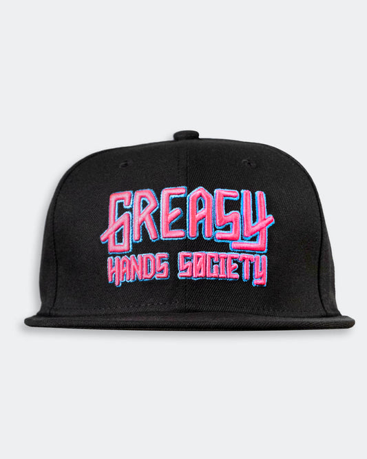 Black cap with pink and blue 'Greasy Hands Society' logo on a light gray background