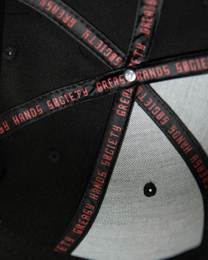 interior of a Black cap with red text on a dark background