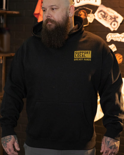 support your local car vclub black heavyweight hoodie on a model showing support local greasy hands on the front left chest