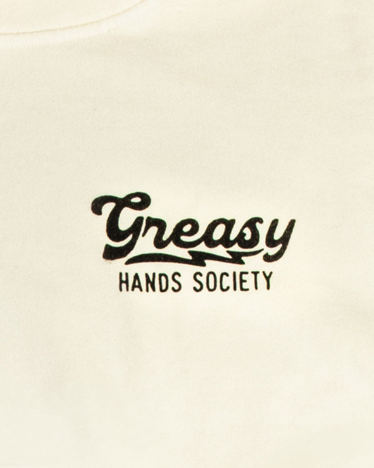 Text 'Greasy Hands Society' on a beige shirt for the destination hoodie