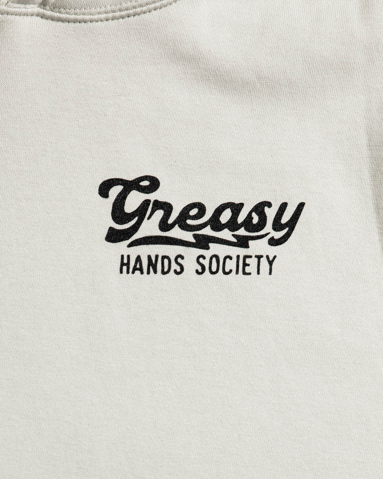 beige sweatshirt with 'Greasy Hands Society' text in black on a white background