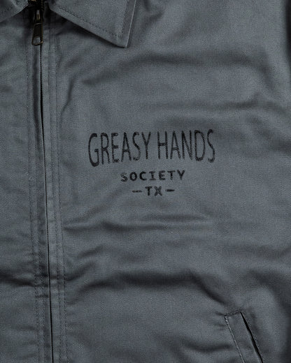 Gray mechanics jacket with 'Greasy Hands Society TX' text 