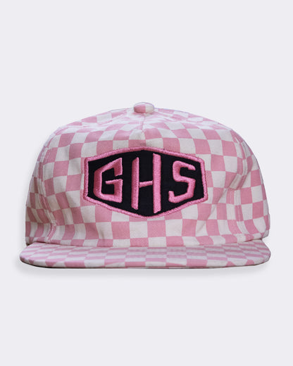 Pink checkered cap with 'GHS' logo on a white background greasy hands society's momentum pink sheckerboard hat