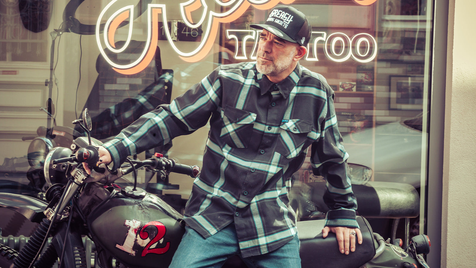 gravity fed flannel for pinstripers a black blue and gray flannel worn by a guy on a motorcycle