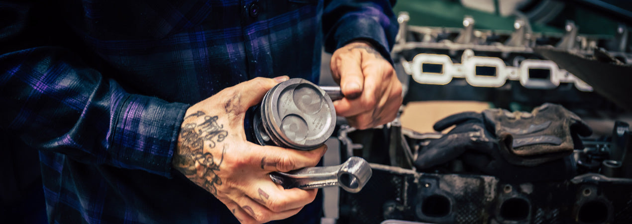 Person working on a car engine with a focus on hands and tools - Kiss the Sky Flannel by Greasy Hands Society