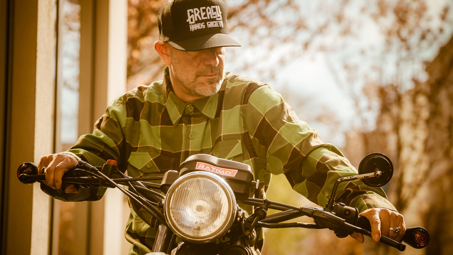 the griswold brown and green flannel worn on a motorbike