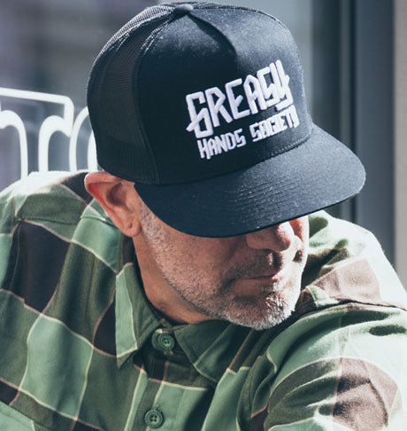 black greasy hands society logo hat with white logo on the front