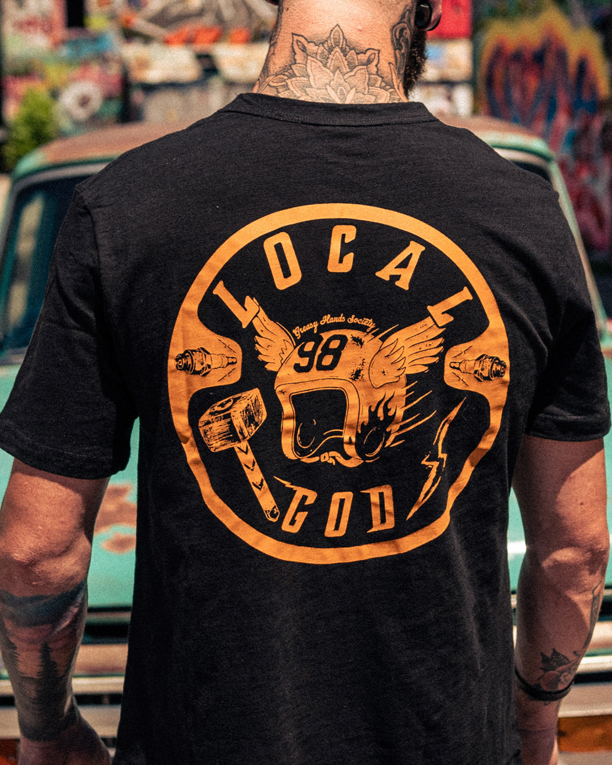 local god black graphic tee full back graphic showing a hammer and winged helmet