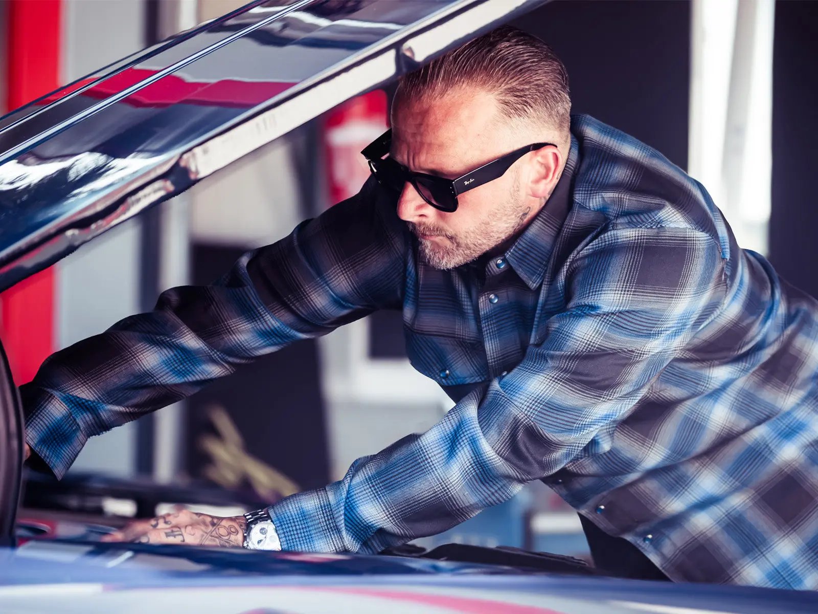 a man fixing a classic car engine wearing a blue and black plaid flannel shirt - The Nailhead Flannel by Greasy Hands Society