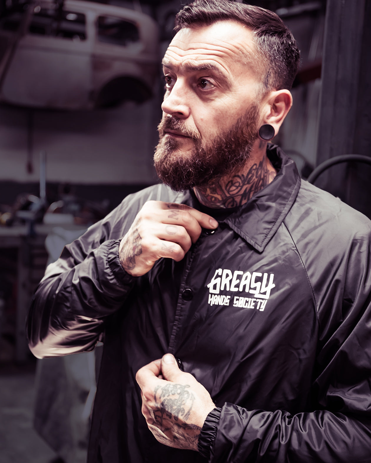 greasy hands society logo jacket front view on a model