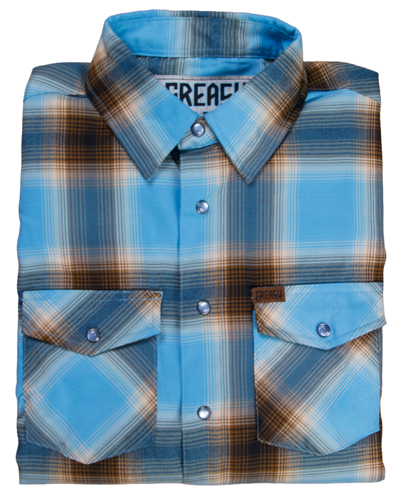 Folded blue and brown plaid flannel shirt with 'Greasy Hands Society' branding on a white background