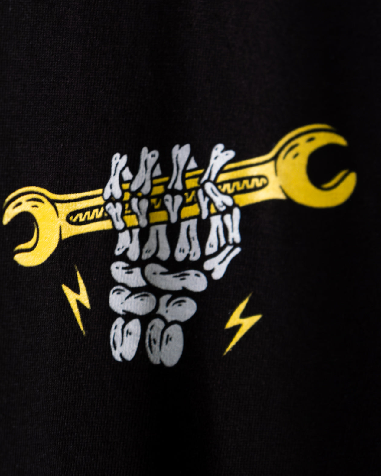  front left chest graphic of a skeleton holding a wrench  - Built for Pride men's black graphic t-shirt by greasy hands society