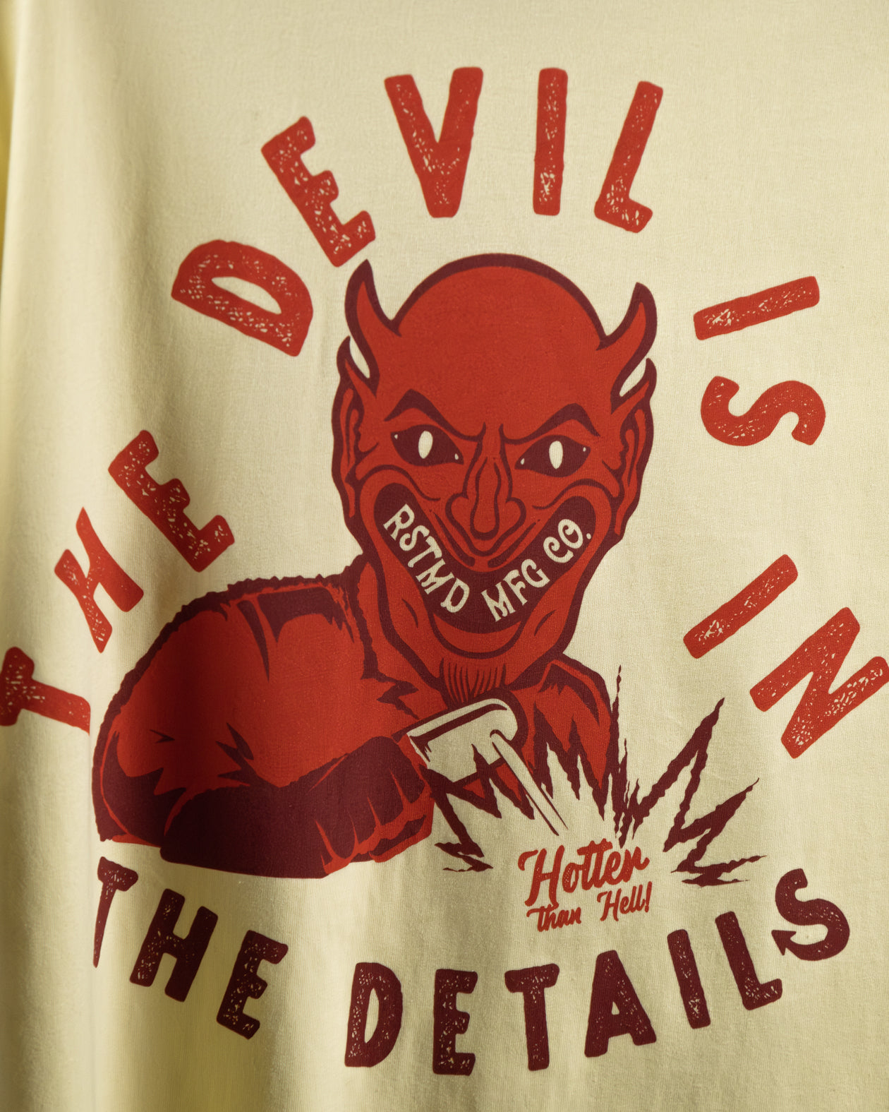 The Devil is in the Details yellow graphic t-shirt full back design detail of a red devil