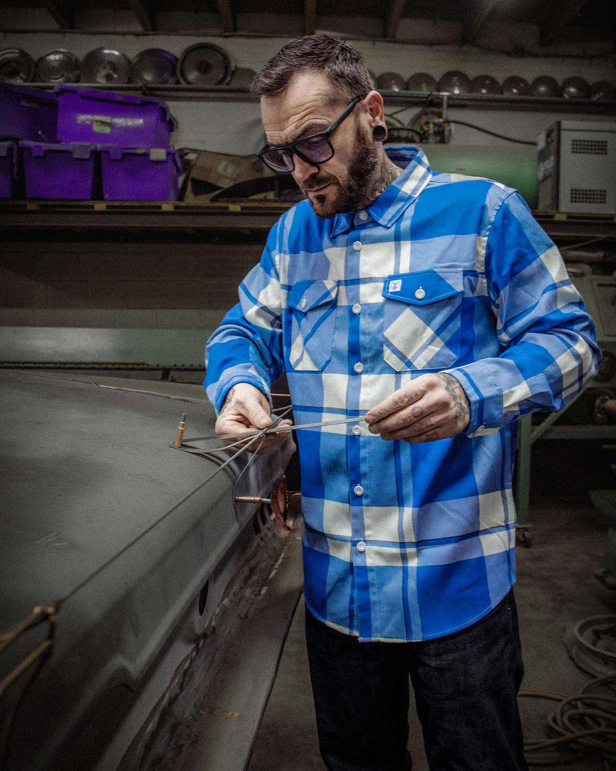 F**kin problems blue and white flannel shirt on a guy working on his car