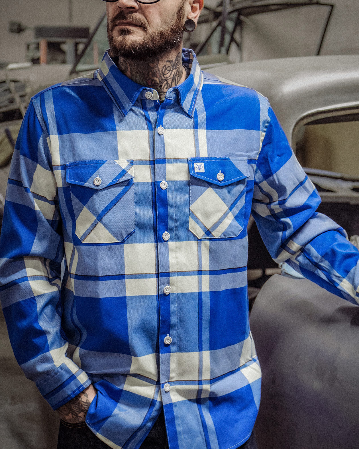 f**kin problems Flannel - a blue & white flannel on a model working with his hands