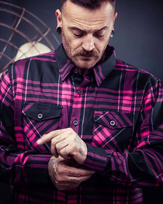 Lonely Heart Flannel black and pink flannel on a model tightening the cuffs