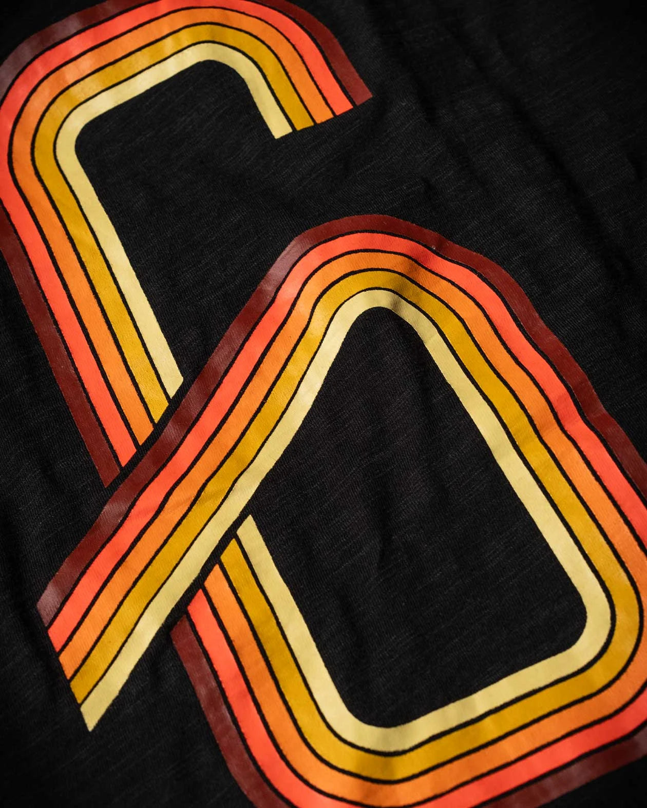 DETAIL OF THE BIG G ON THE BACK - G70 graphic tee from Greasy Hands Society