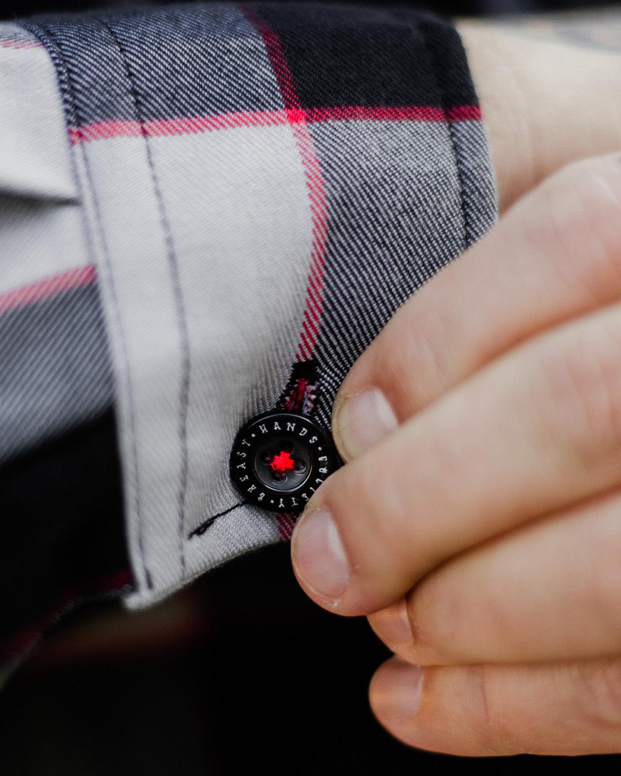 black red and gray flannel barrel cuff on the banger flannel showing greasy hands society button
